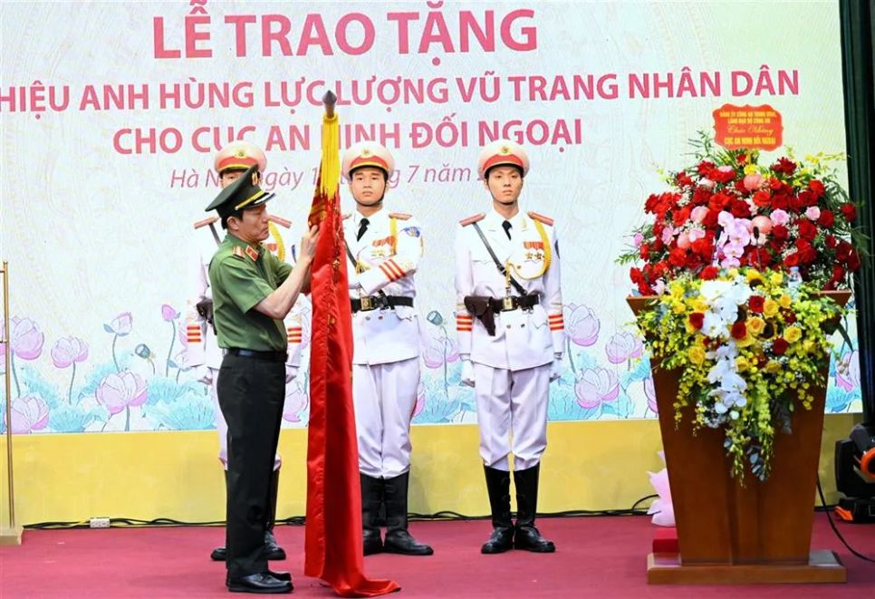 Bộ trưởng Lương Tam Quang trân trọng gắn danh hiệu Anh hùng lực lượng vũ trang nhân dân lên lá cờ truyền thống của Cục An ninh đối ngoại. Ảnh: Cổng thông tin Bộ Công an Bộ trưởng Lương Tam Quang trân trọng gắn danh hiệu Anh hùng lực lượng vũ trang nhân dân lên lá cờ truyền thống của Cục An ninh đối ngoại. Ảnh: Cổng thông tin Bộ Công an