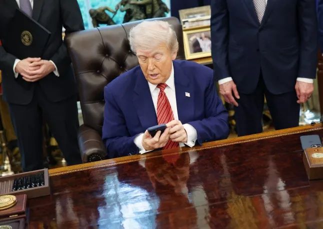 <p>Tổng thống Donald Trump cầm iPhone trong buổi ký lệnh hành pháp tại Phòng Bầu dục của Nhà Trắng vào tháng 5 (Ảnh: Getty Images)</p>