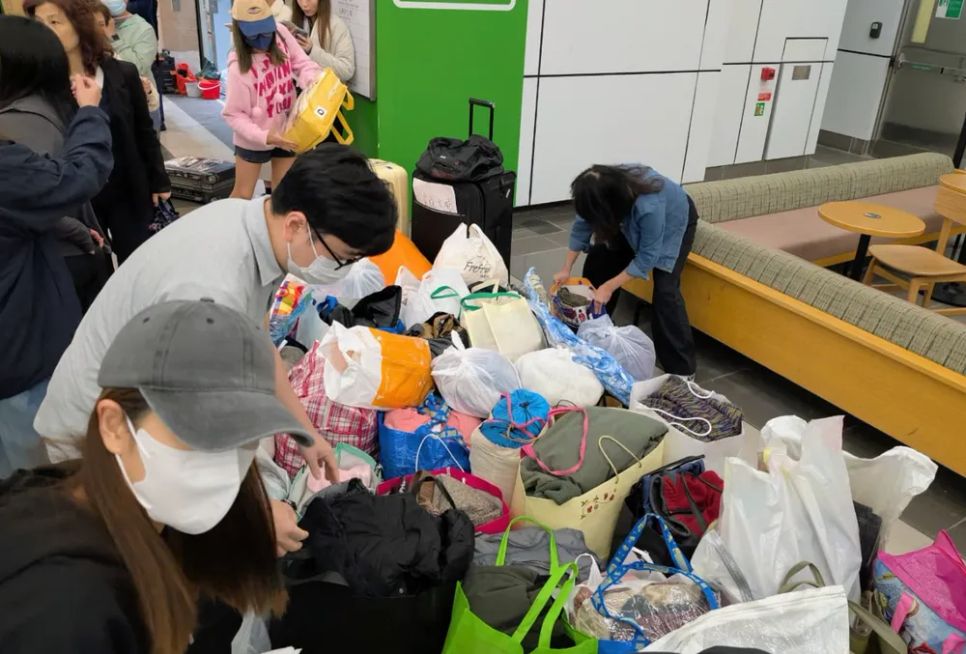 Tiếp tế nhu yếu phẩm hỗ trợ người dân trong vụ cháy. Ảnh: HKFP