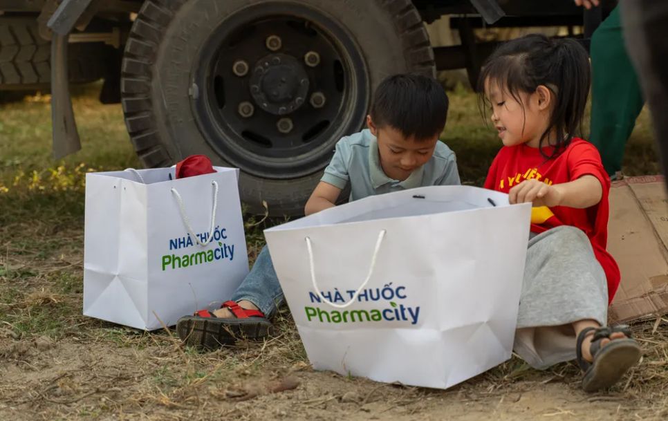 Các em nhỏ vui mừng khui quà vừa được nhận Các em nhỏ vui mừng khui quà vừa được nhận