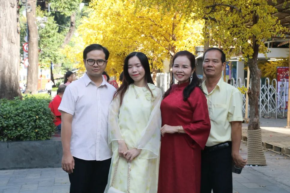 Các gia đình chụp ảnh kỷ niệm tại đường mai Lễ hội Tết Việt. Ảnh: TIỂU TÂN Các gia đình chụp ảnh kỷ niệm tại đường mai Lễ hội Tết Việt. Ảnh: TIỂU TÂN