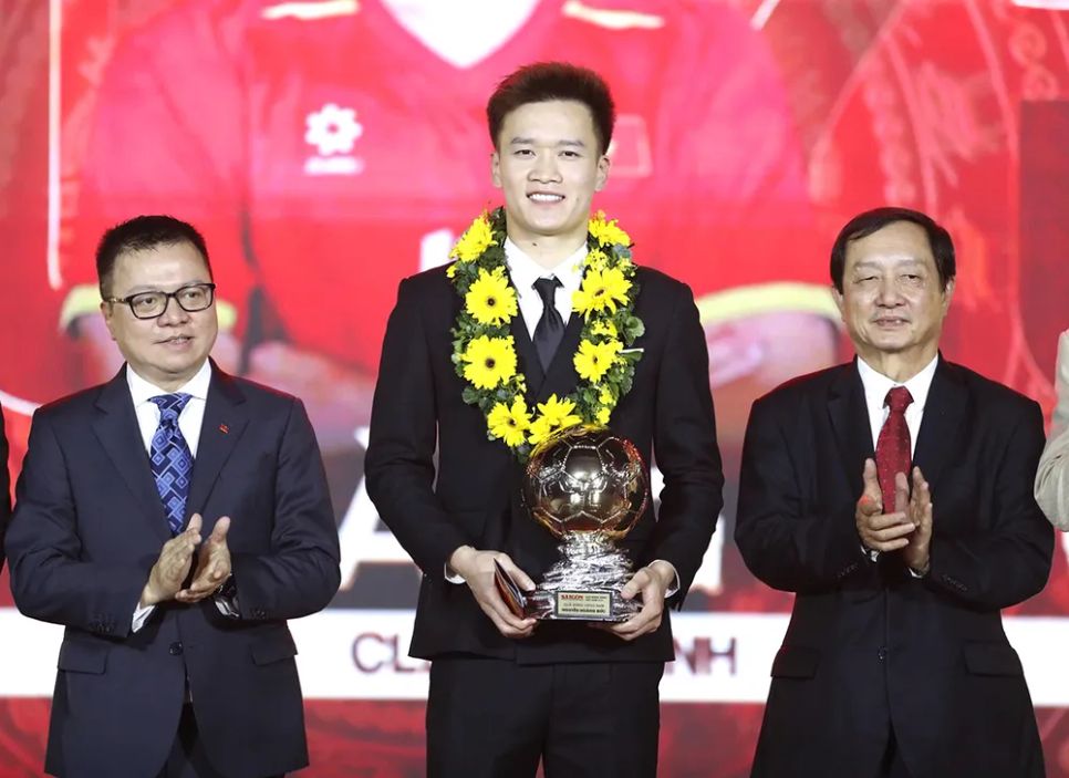 Từ trái sang: Ông Lê Quốc Minh, Ủy viên Trung ương Đảng, Phó Trưởng Ban Tuyên giáo và Dân vận trung ương, Tổng Biên tập Báo Nhân Dân, Chủ tịch Hội Nhà báo Việt Nam; ông Huỳnh Thành Đạt, Phó Trưởng Ban Tuyên giáo và Dân vận Trung ương, trao danh hiệu QBV nam 2025 cho cầu thủ Nguyễn Hoàng Đức. Từ trái sang: Ông Lê Quốc Minh, Ủy viên Trung ương Đảng, Phó Trưởng Ban Tuyên giáo và Dân vận trung ương, Tổng Biên tập Báo Nhân Dân, Chủ tịch Hội Nhà báo Việt Nam; ông Huỳnh Thành Đạt, Phó Trưởng Ban Tuyên giáo và Dân vận Trung ương, trao danh hiệu QBV nam 2025 cho cầu thủ Nguyễn Hoàng Đức.