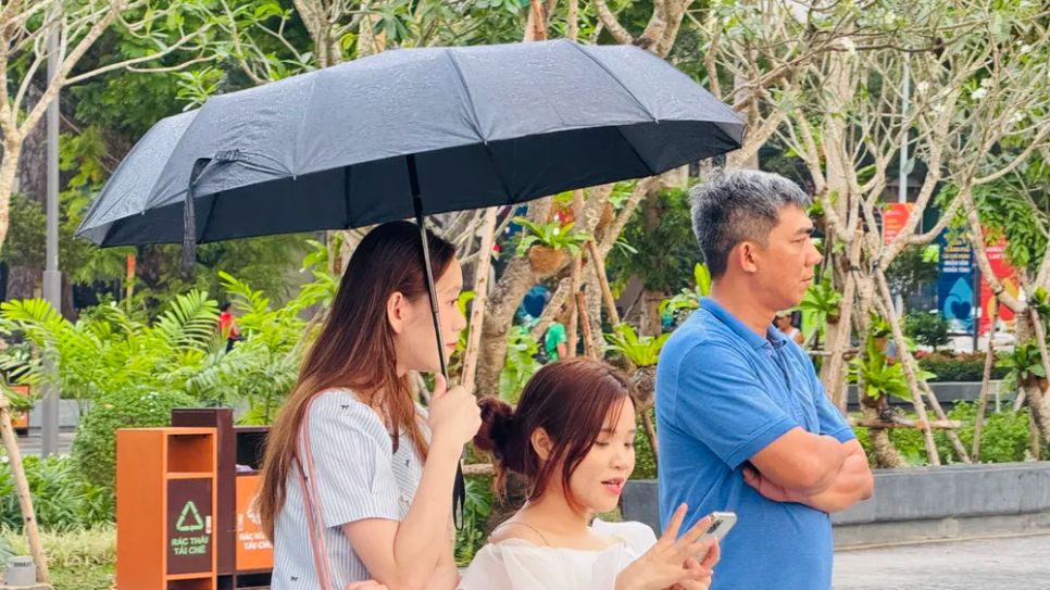 Bất chấp trời mưa lất phất, người dân vẫn hào hứng ngắm cảnh quan công viên. Ảnh: ĐÌNH DƯ