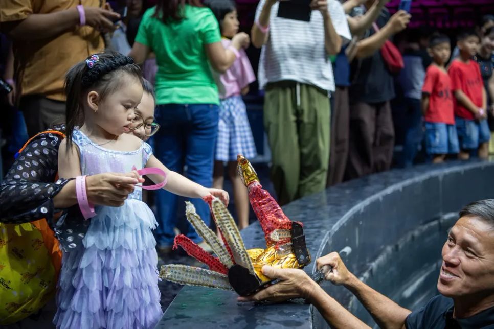 Mẹ và bé cùng khám phá sự mới lạ của con rối. Ảnh: DŨNG PHƯƠNG