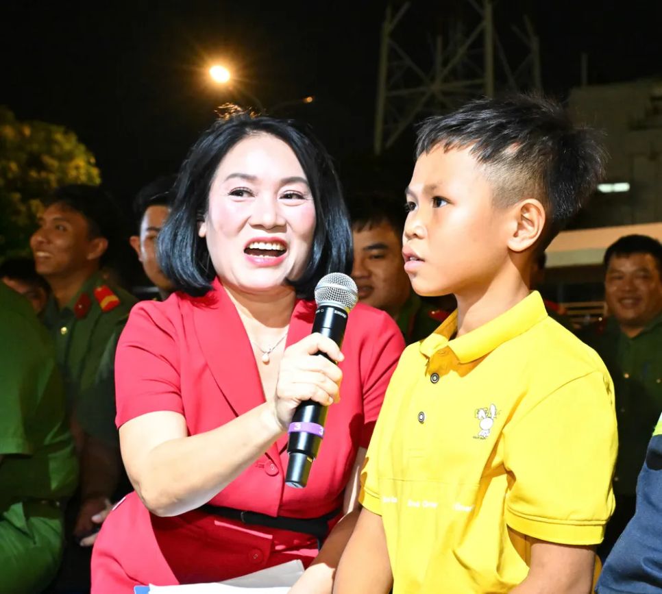 Nhà báo Tạ Bích Loan giao lưu với bé trai được lực lượng Cảnh sát PCCC-CNCH Công an TPHCM giải cứu bị mắc kẹt giữa hai bức tường. Ảnh: VIỆT DŨNG