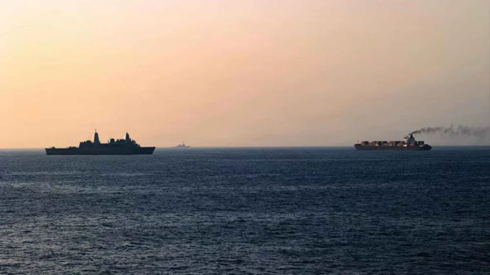 Tàu chiến Mỹ (trái) theo dõi tàu chở hàng Iran tại biển Arab, ngày 20-4 (ẢNH: US NAVY)