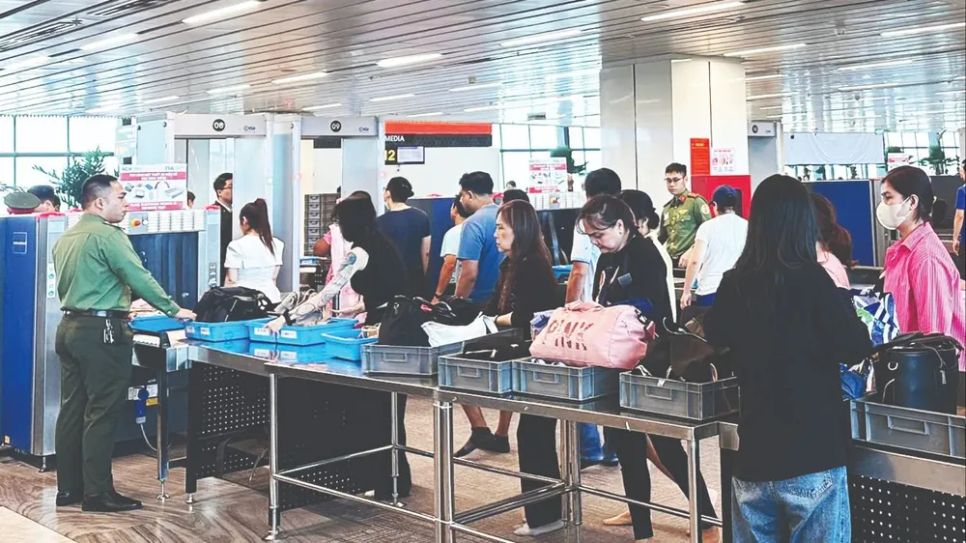 Hành khách qua cửa kiểm tra an ninh tại nhà ga T3 sân bay Tân Sơn Nhất (ẢNH: QUỐC HÙNG)