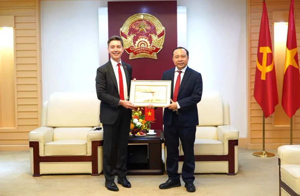 Bộ trưởng Vũ Hải Quân trao quà lưu niệm đến Đại sứ Julien Guerrier tại cuộc tiếp. Ảnh: MST